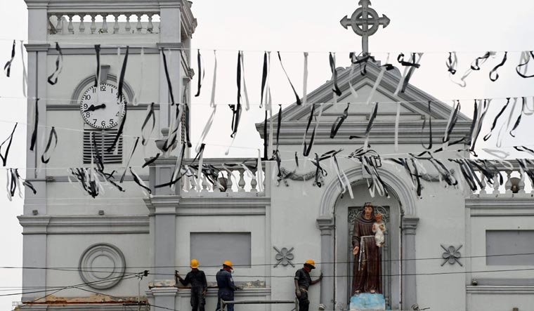 Sri Lankan navy personnel carry on repair works on the facade of St. Anthony's Shrine in Colombo | AFP