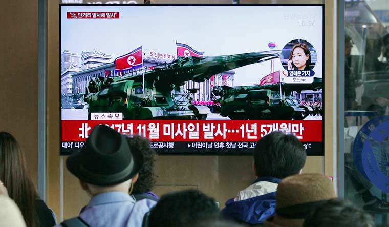 People watch a TV showing a file footage of North Korea's missiles during a military parade in Pyongyang during a news program at the Seoul Railway Station in Seoul, South Korea | AP