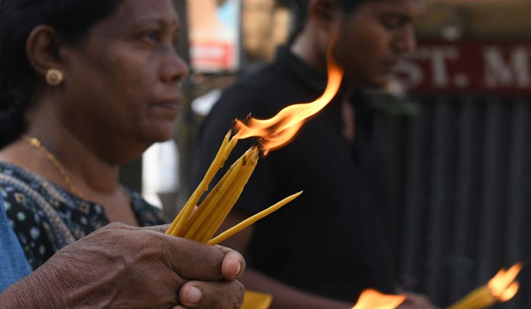Sri Lankan Christians pray at a barricade near St. Anthony's Shrine in Colombo | AFP