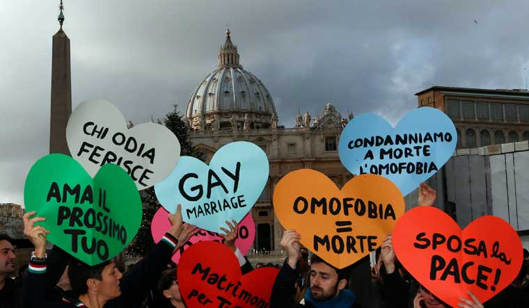 Members of a gay activist group hold signs in front of St. Peter's square in the Vatican December 16, 2012 protesting against the Roman Catholic Church's rejection of homosexuality and gay marriage | Reuters