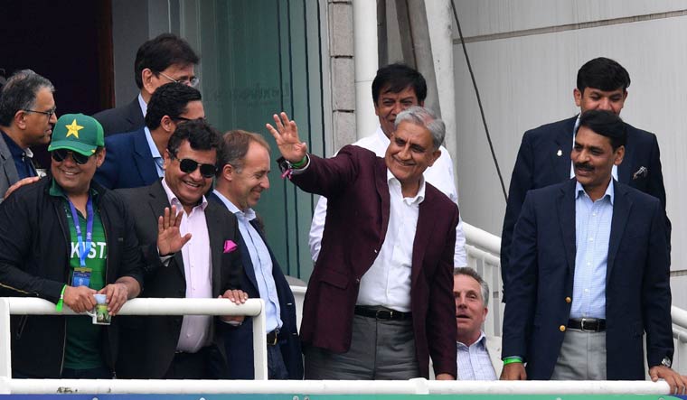 Pakistan Army Chief General Qamar Javed Bajwa waves to the crowd during the 2019 Cricket World Cup group stage match between Pakistan and South Africa at Lord's; Major General Asif Ghafoor is to his right | AFP