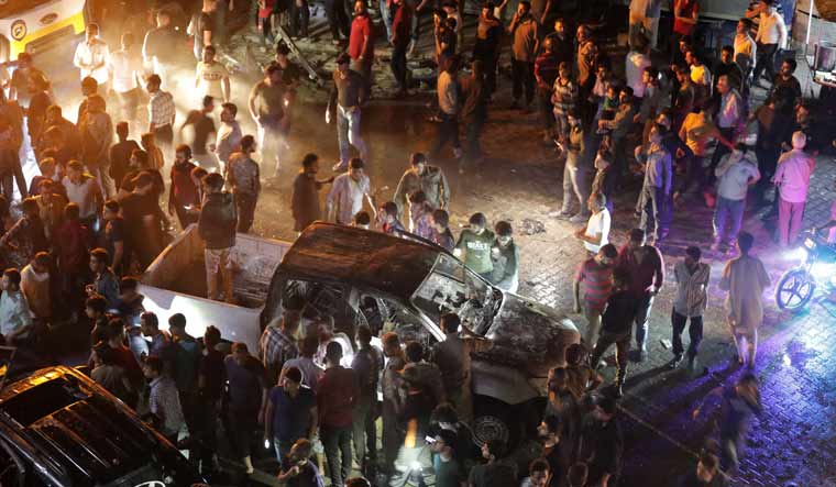 People gather at the site of a car bomb blast in Azaz, Syria | Reuters