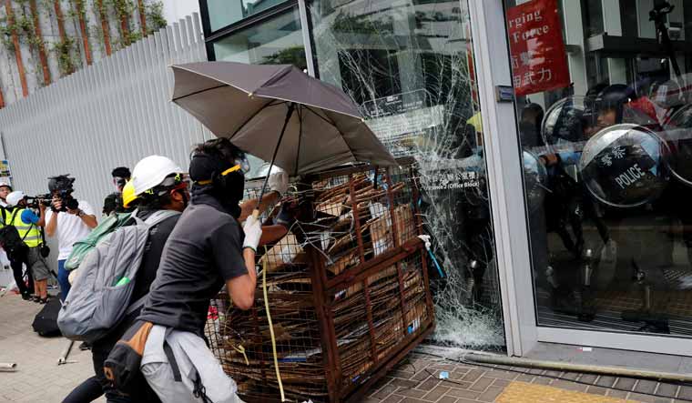 Protesters try to break into Hong Kong's Legislative Council building | Reuters