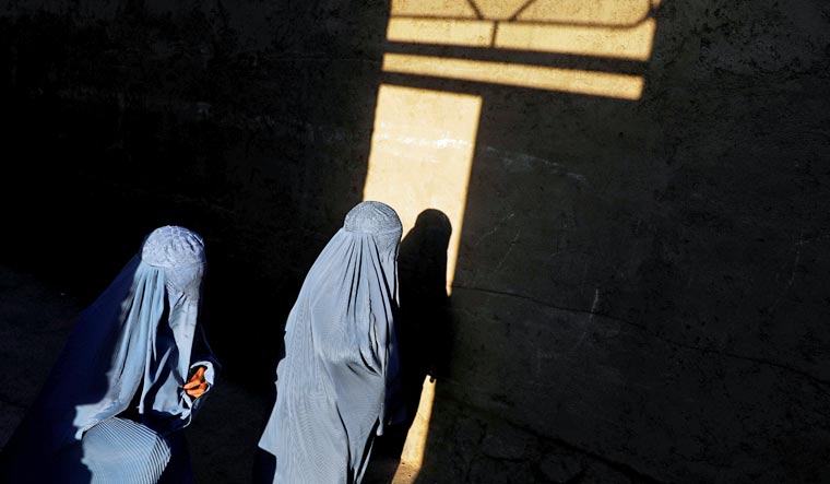 Afghan women, clad in burqas, walk in Herat province, Afghanistan | Reuters