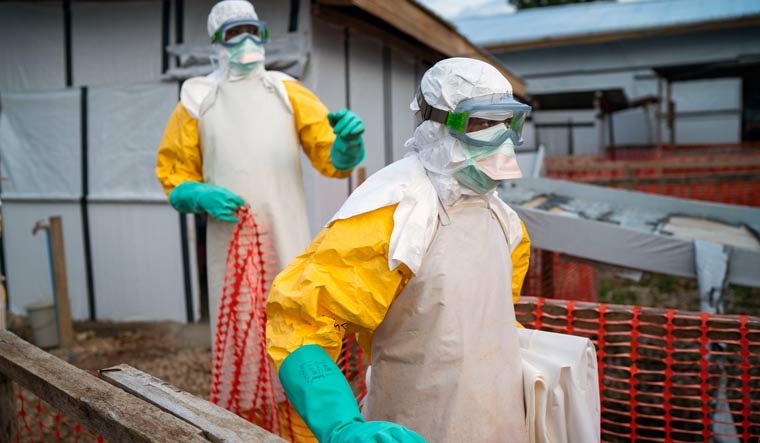 Health workers wearing protective suits take their shift at a treatment center in Beni, Congo | AP