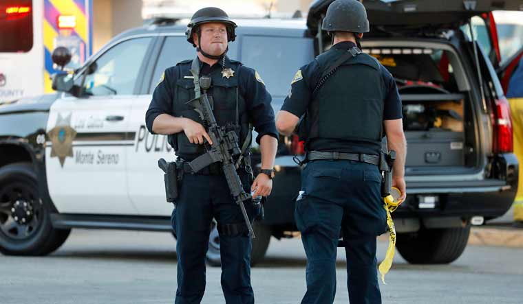 Police stand guard outside Gilroy High School following a deadly shooting at the Gilroy Garlic Festival in Gilroy, California | AFP