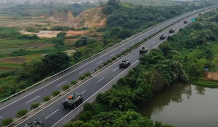 A screenshot from the video, showing Armoured Personal Carriers (APCs) heading towards Shenzhen to mobilize | Global Times