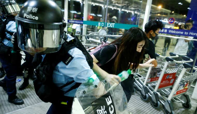 Riot police deploy pepper spray at the Hong Kong international airport | Reuters