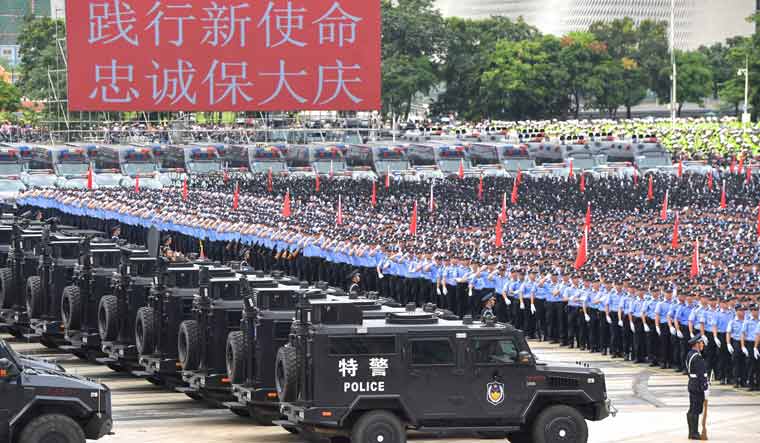 Chinese paramilitary forces parade near Hong Kong border
