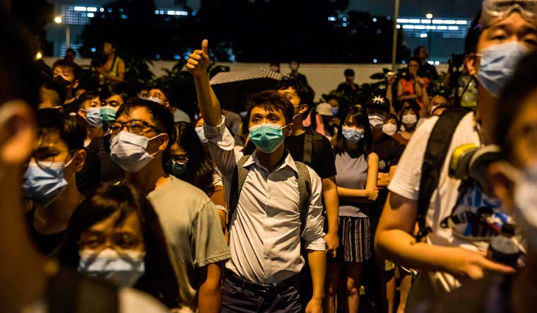 Protesters gather in support of protesters detained with the charge of rioting in Hong Kong | AFP