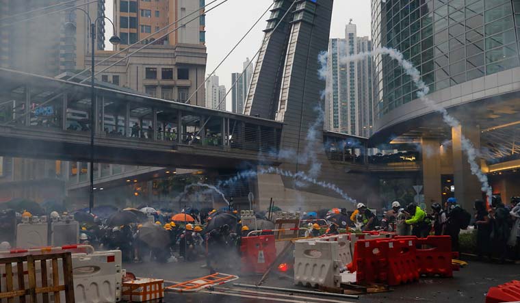 Demonstrators scramble during a protest in Hong Kong, Sunday, August 25, 2019 | AP