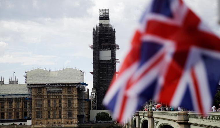 The Houses of Parliament are seen, with a Union Jack flag in the foreground, in central London, Wednesday, Aug. 28 | AP