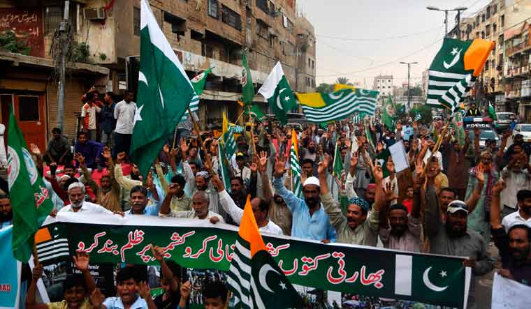 Demonstrators shout slogans during an anti-India protest rally in Karachi | AFP