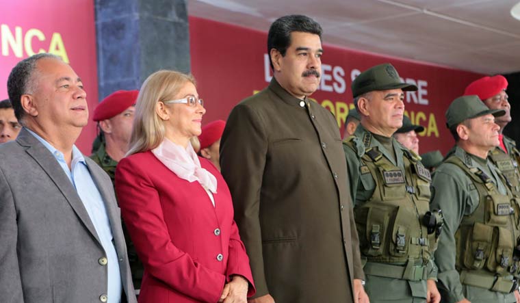 Venezuela's President Nicolas Maduro (C) flanked by his wife Cilia Flores (L) and Defense Minister Vladimir Padrino | AFP