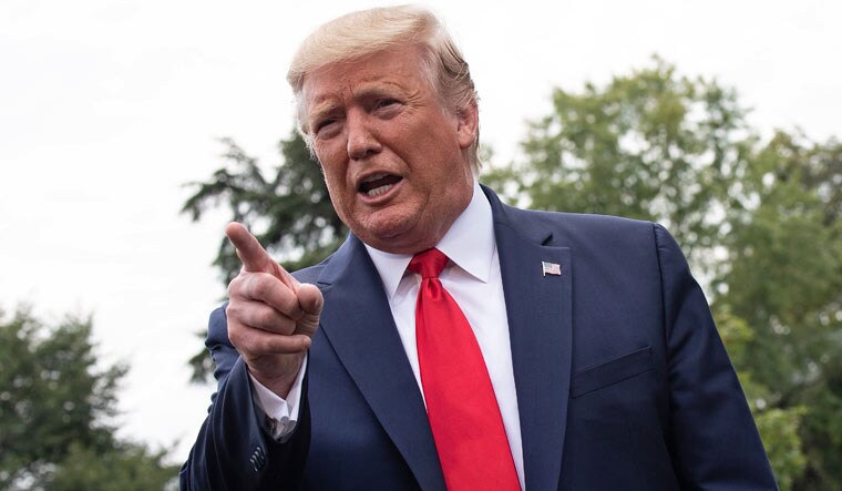 US President Donald Trump speaking to mediapersons outside the White House | AFP
