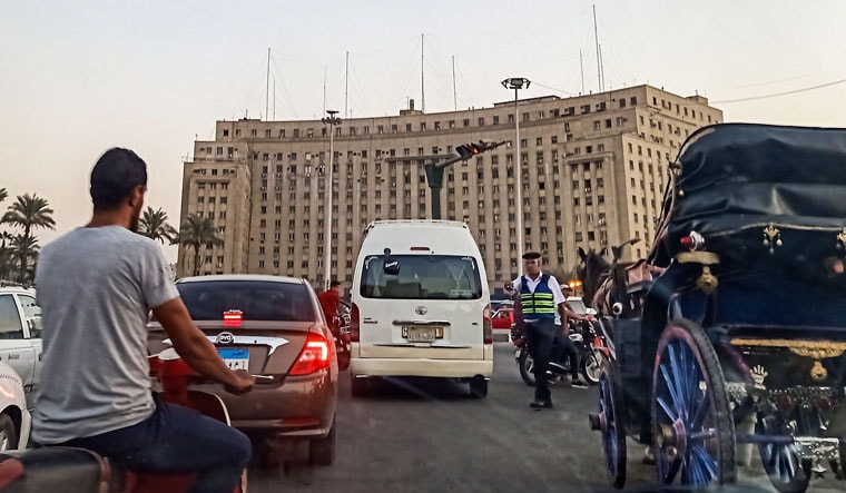 A policeman stops traffic traversing the roundabout in the Egyptian capital Cairo's central Tahrir Square | AFP