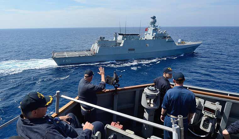 The crew of a US Navy vessel watch the TCG Heybeliada, a MILGEM vessel of the Turkish Navy | Wikipedia Commons