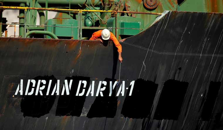 A crew member takes pictures with a mobile phone on Iranian oil tanker Adrian Darya 1 | Reuters