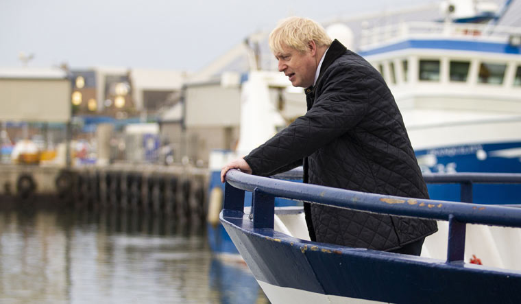 Britain's Prime Minister Boris Johnson looks on from aboard the Opportunis IV fishing trawler during a visit to Peterhead in Scotland on September 6, 2019 | AFP