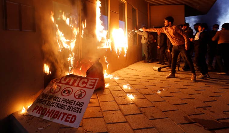 Protesters and militia fighters set fire to a reception room of the US Embassy in Baghdad | Reuters