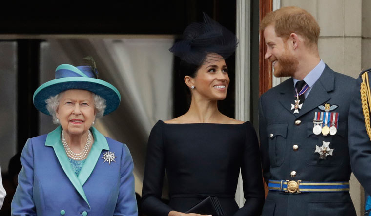 File photo of Britain's Queen Elizabeth II, Meghan the Duchess of Sussex and Prince Harry | AP