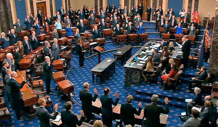 Presiding officer Supreme Court Chief Justice John Roberts swears in members of the Senate for the impeachment trial against President Donald Trump at the US Capitol in Washington | AP