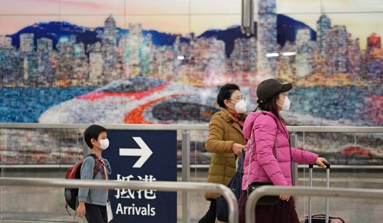 Passengers wear masks at the high-speed train station in Hong Kong | AP