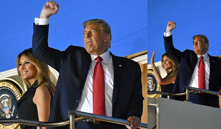 US President Donald Trump and US First Lady Melania Trump gesture and wave as they board Air Force One to depart Nashville International Airport after the final presidential debate in Nashville, Tennessee | AFP