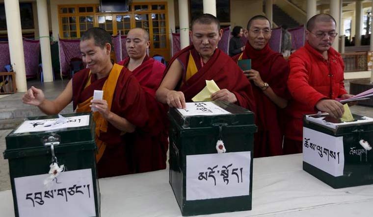 [File] Tibetan monks cast their vote during the election for the Tibetan government-in-exile at a polling booth in Dharamsala, on March 20, 2016 | Reuters