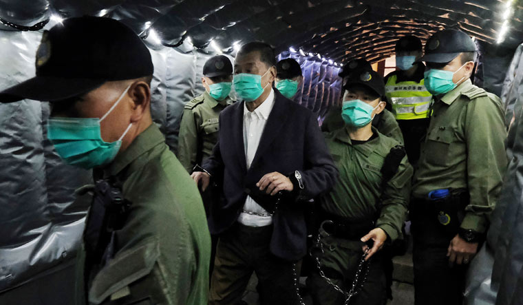 Hong Kong pro-democracy activist and media tycoon Jimmy Lai, center left, is escorted by Correctional Services officers to get on a prison van at the Court of Final Appeal in Hong Kong | AP