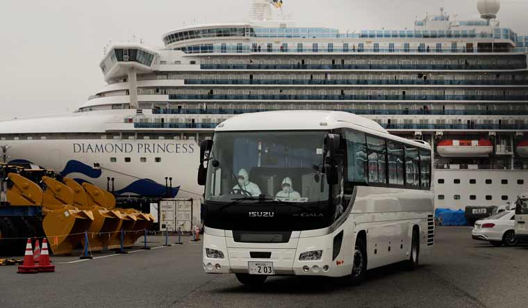 A bus leaves a port where the quarantined Diamond Princess cruise ship is docked, in Yokohama, near Tokyo | AP