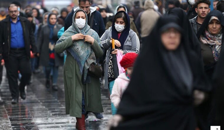 Iranian women wear protective masks to prevent contracting a coronavirus, as they walk at Grand Bazaar in Tehran, Iran | Reuters