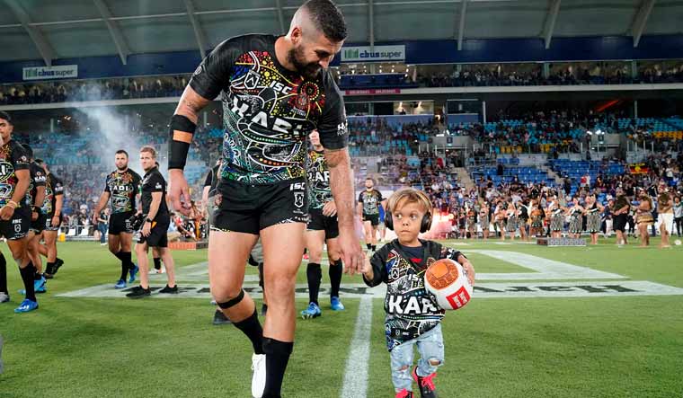 File: Nine-year-old Quaden Bayles, right, leads the Indigenous All Stars on to the field with captain Joel Thompson prior to the National Rugby League Indigenous All-Stars vs Maori Kiwis match at on the Gold Coast | AP