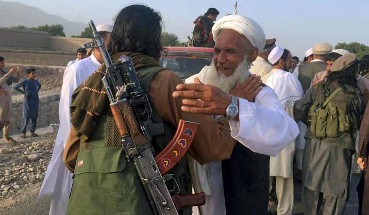 File: Taliban fighters gather with residents to celebrate a three-day cease fire marking the Islamic holiday of Eid al-Fitr, in Nangarhar province, east of Kabul, Afghanistan | AP