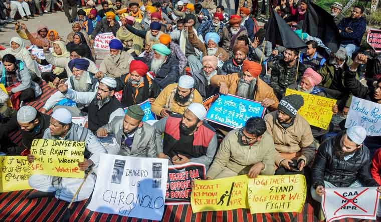 People hold placards and raise slogans during a protest march against the Citizenship Amendment Act (CAA), National Register of Citizens (NRC), the National Population Register (NPR), in Amritsar | PTI