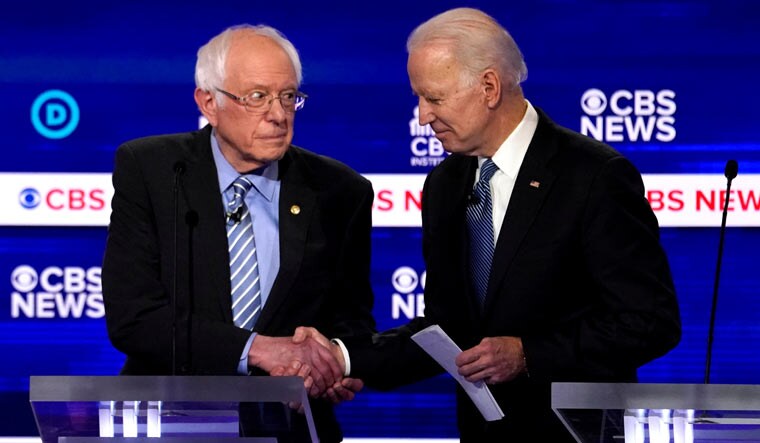 (File) US presidential candidates Senator Bernie Sanders shakes hands with former vice-president Joe Biden after the 1oth Democratic 2020 presidential debate at the Gaillard Center in Charleston, South Carolina | Reuters