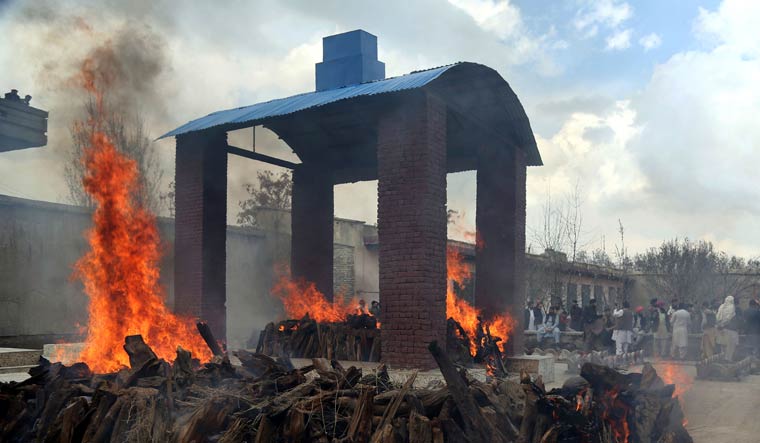 Afghan Sikh men attend a funeral procession and cremation ceremony for those who were killed on Wednesday by a lone Islamic State gunman, rampaged through a Sikh house of worship, in Kabul, Afghanistan, Thursday, March 26, 2020 | AP