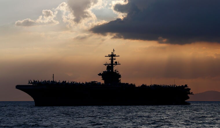 File photo of the USS Theodore Roosevelt aircraft carrier, anchored off Manila Bay in the Philippines in 2017. The 104,600-ton ship has around 5,000 crew members and carries around 90 aircraft | AP