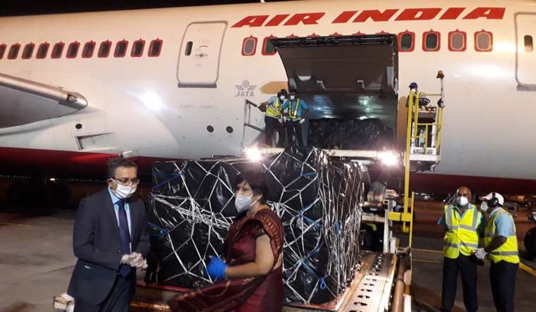 Mauritius Vice-PM Leela Devi Luchoomu Dookun receiving the first consignment of half a million tablets of Hydroxychloroquine and 12 tons of other lifesaving medicines from a special Air India cargo flight sent by India | Indian embassy in Mauritius Twitter handle