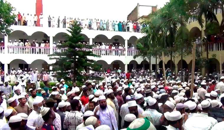 Thousands of Bangladeshi Muslims gather to attend the funeral of a popular Islamic preacher defying a nationwide lockdown on April 18 | AP