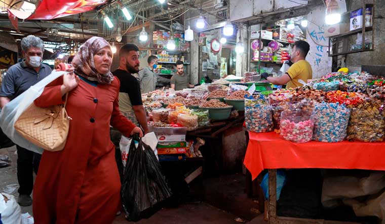 People shop in preparation for the Muslim fasting month of Ramadan, in Baghdad, Iraq | AP