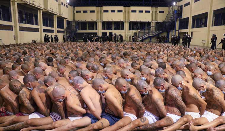 In this photo released by the El Salvador Presidency Press Office, inmates are lined up during a security operation under the watch of police at the Izalco prison in San Salvador, El Salvador, Saturday, April 25, 2020 | El Salvador President Press Office via AP