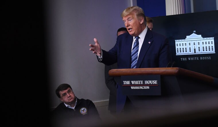 US President Donald Trump speaks during an unscheduled briefing after a Coronavirus Task Force meeting at the White House on Sunday | AFP