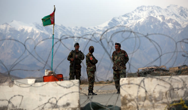 Afghan National Army soldiers stand guard at a checkpoint near the Bagram base in northern Kabul | AP