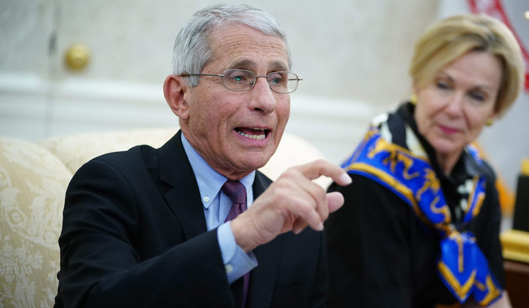 Dr. Anthony Fauci (L), director of the National Institute of Allergy and Infectious Diseases, speaks next to Response coordinator for White House Coronavirus Task Force Deborah Birx during a meeting with US President Donald Trump and Louisiana Governor John Bel Edwards D-LA in the Oval Office of the White House in Washington | AFP
