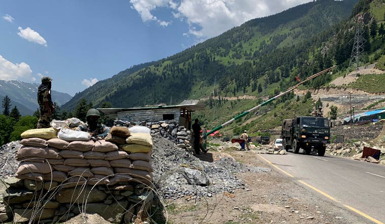 Indian paramilitary soldiers keep guard as an Army convoy moves on the Srinagar- Ladakh highway at Gagangeer | AP