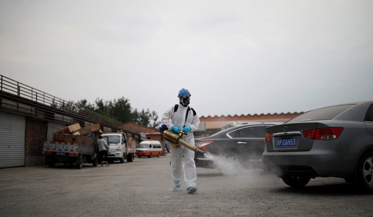 A volunteer from the Blue Sky Rescue Team, in a protective suit, disinfects the Nangong comprehensive market following a new COVID-19 outbreak in Beijing, China, June 18, 2020 | REUTERS