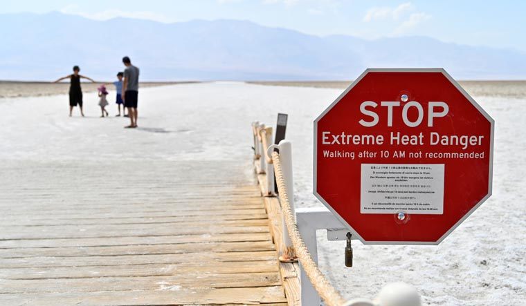 A warning sign alerts visitors of the extreme heat dangers at Badwater Basin, the lowest point in North America at 279 feet below sea level, in Death Valley National Park, California | Reuters