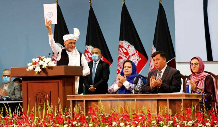 Afghan President Ashraf Ghani holds up the resolution on the last day of an Afghan Loya Jirga or traditional council, in Kabul, Afghanistan, Sunday, August 9, 2020 | AP