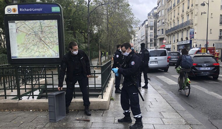 Police officers stand by a knife, seen on the ground, in Paris, Friday. French terrorism authorities are investigating a knife attack that wounded at least two people Friday near the former offices of the satirical newspaper Charlie Hebdo in Paris, authorities said. A suspect has been arrested | AP